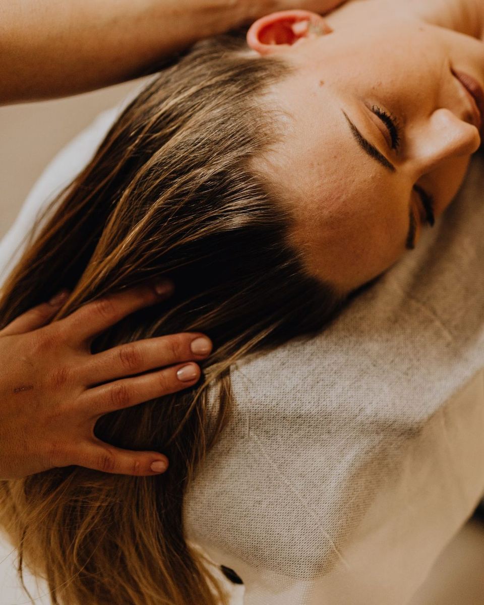 Light hands resting on the head during an Access Bars session